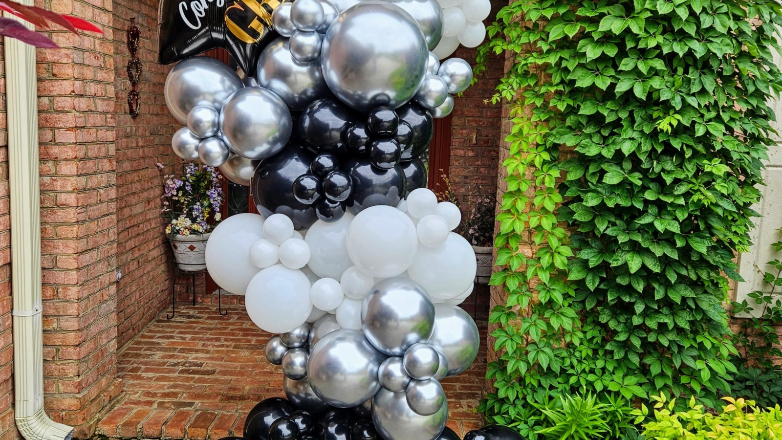 Grab and Go graduation balloon column in black, white, and silver with celebratory foil topper, perfect for quick and stylish event décor by Fabyoulista in Warner Robins, GA.